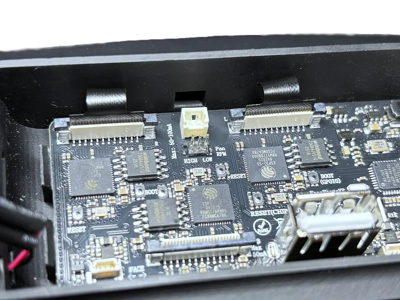 Black connector tabs lifted upward to open the ZIF connector