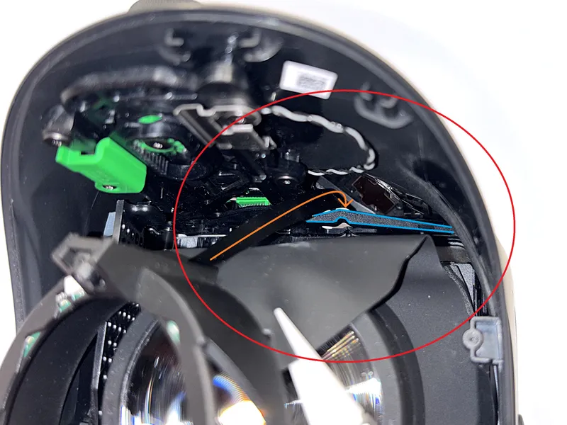 Guiding the right ribbon cable behind the plastic piece